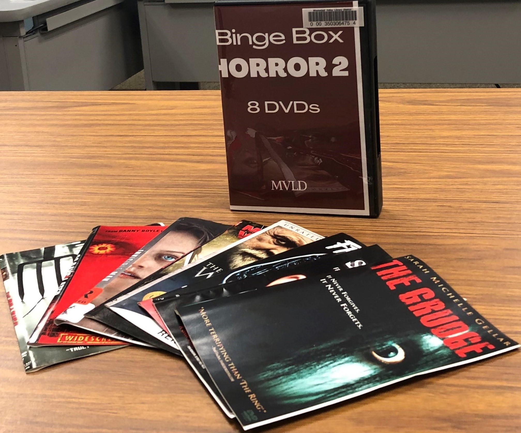 Photo of a DVD case labeled Binge Box: Horror 2 and several booklets